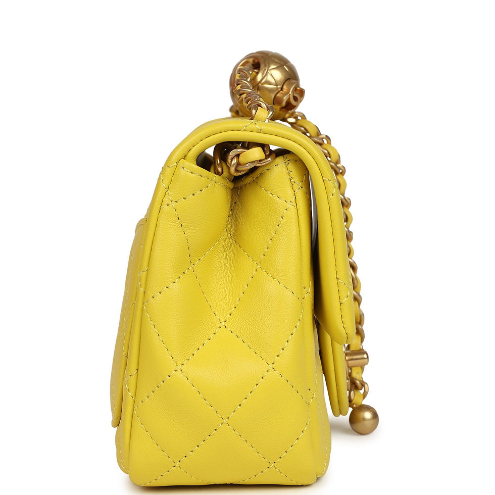 Thumbnail: Side view of the yellow lambskin flap bag with the quilted gold sphere charm on the chain