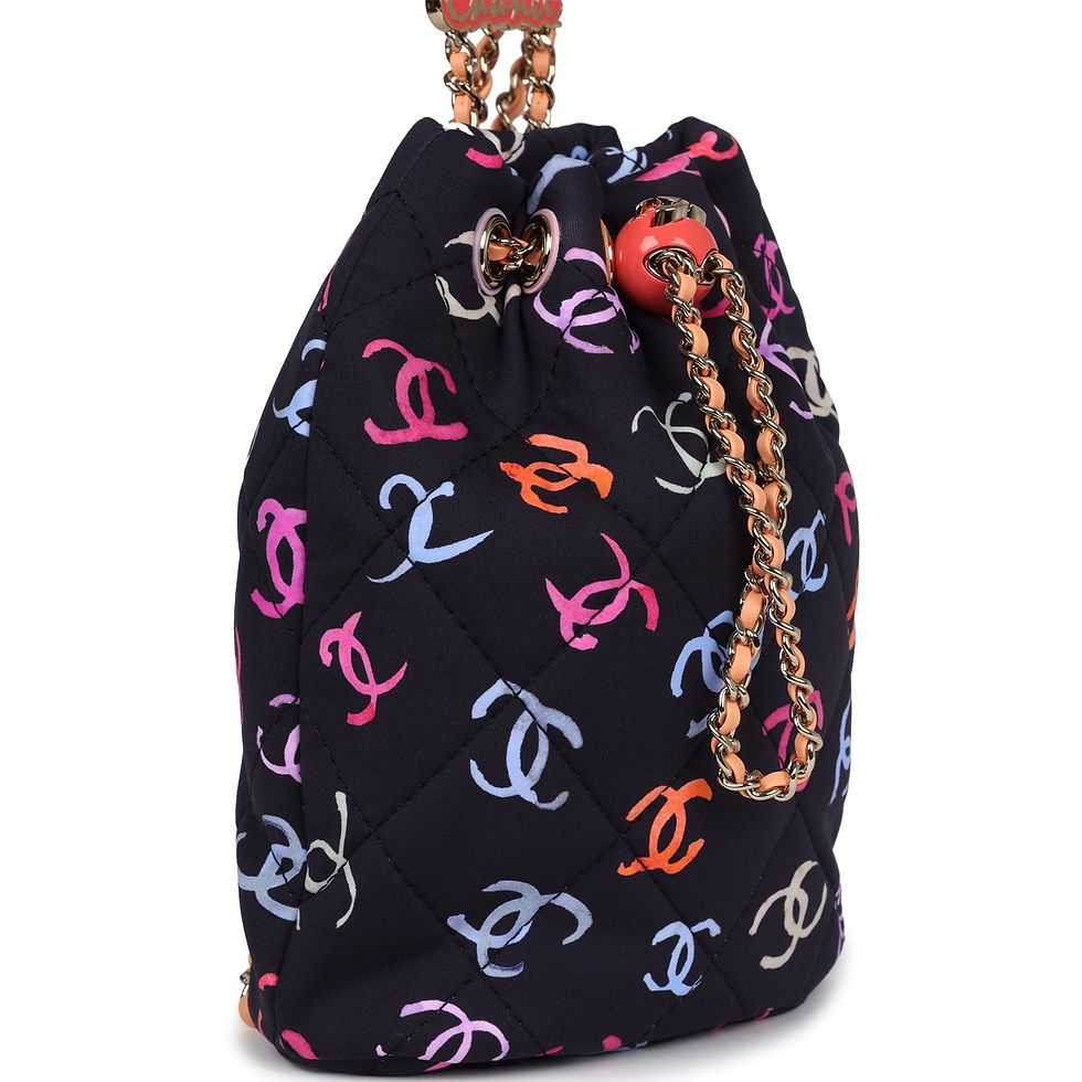 Three-quarter view of the drawstring backpack showing the coral toggle and chain straps