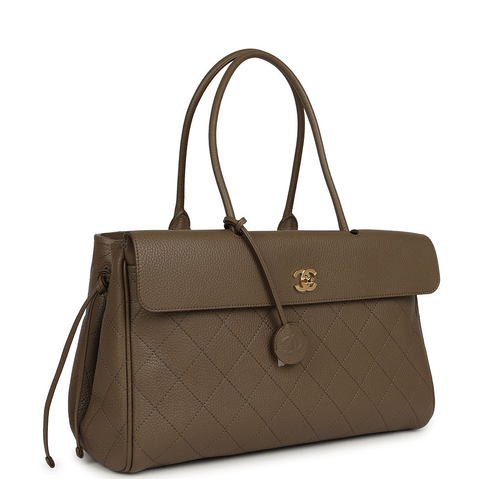 Three-quarter view of the tote showing the side drawstring gather and chain strap