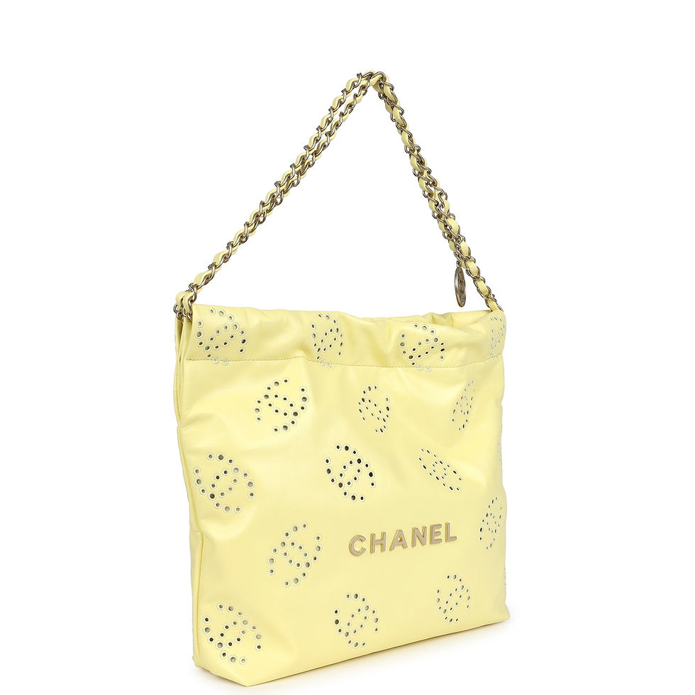 Angled front view of the yellow eyelet bag showing the perforated CC pattern and CHANEL wordmark