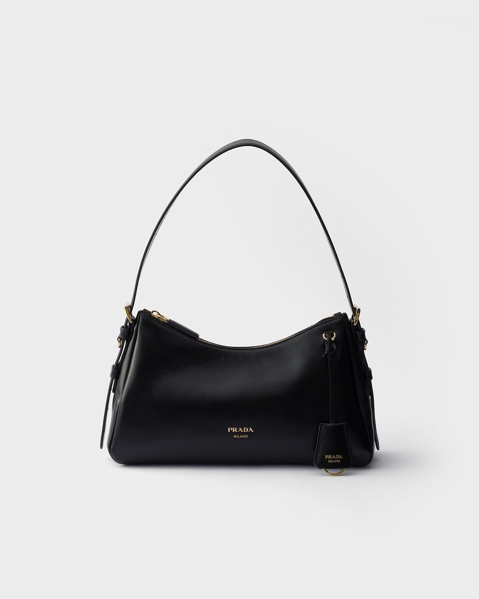 Prada Aimée medium shoulder bag in black leather with embossed logo – front view