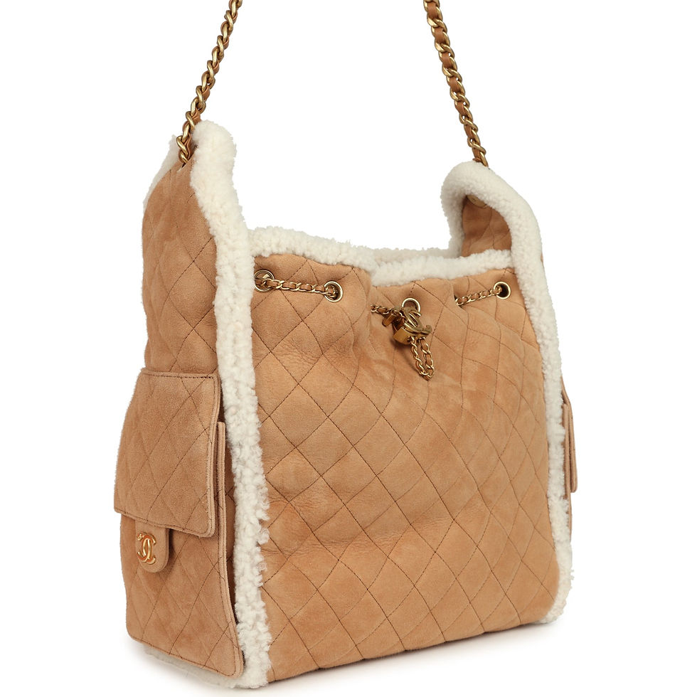 Angled front view showing quilted beige suede, white shearling and gold-tone hardware