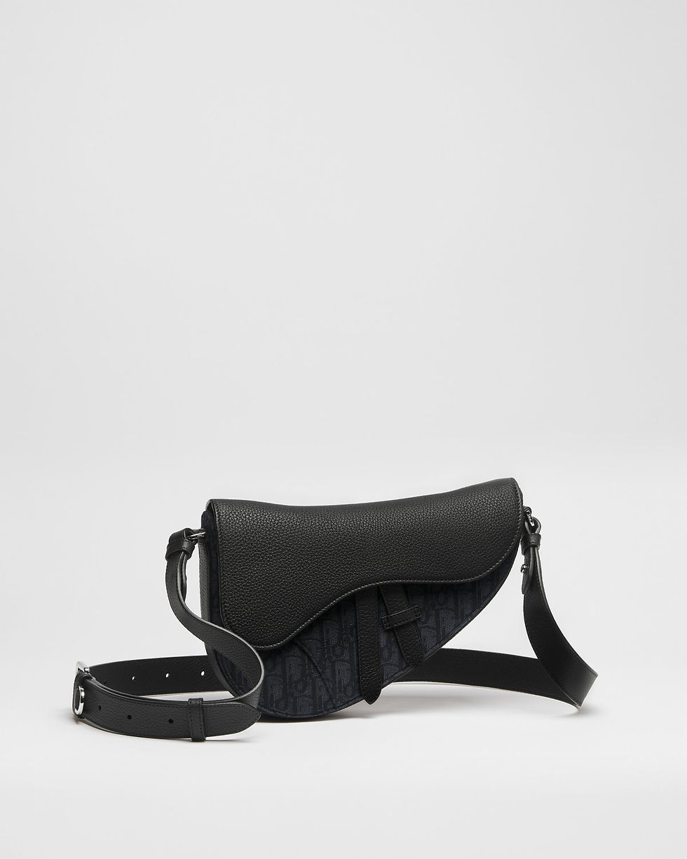 Dior Saddle bag in black Dior Oblique jacquard and Taurillon leather – three-quarter view with strap