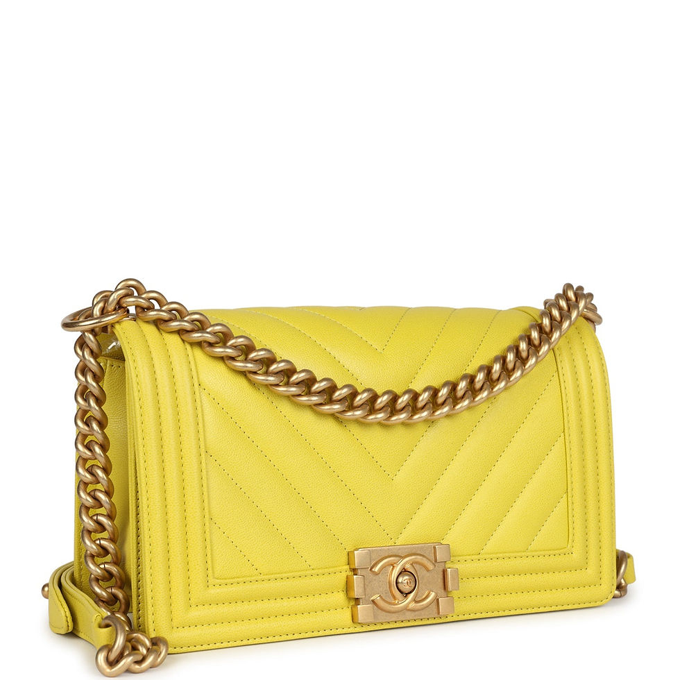 Angled front view highlighting the yellow chevron quilting and brushed gold-tone Boy hardware