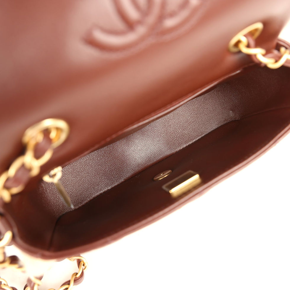 Thumbnail: Open interior of the bag showing the brown leather lining and embossed Chanel logo