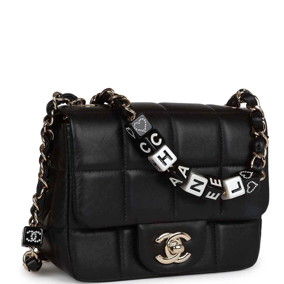 Three-quarter angled view showing the square-quilted panels and CHANEL letter-charm chain strap