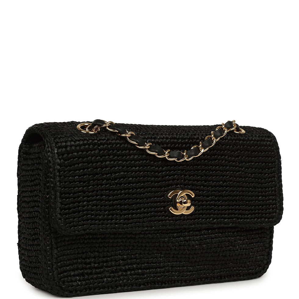 Three-quarter angle showing the woven raffia texture and gold chain-and-leather strap