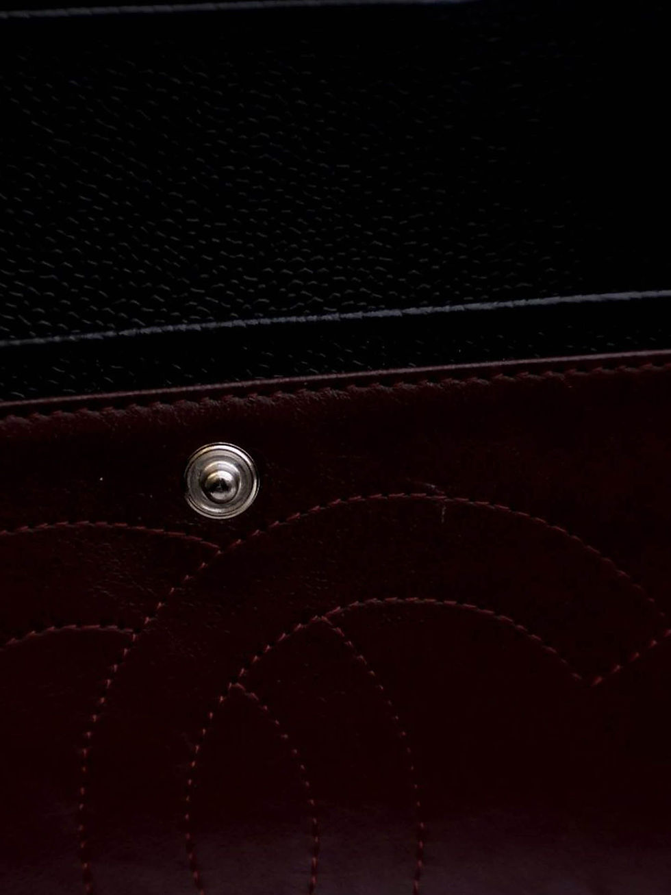 Thumbnail: Interior of the Chanel double flap revealing its burgundy leather lining