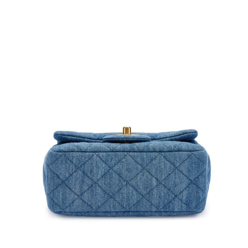 Thumbnail: Side profile of the blue denim Chanel mini flap showing its slim depth