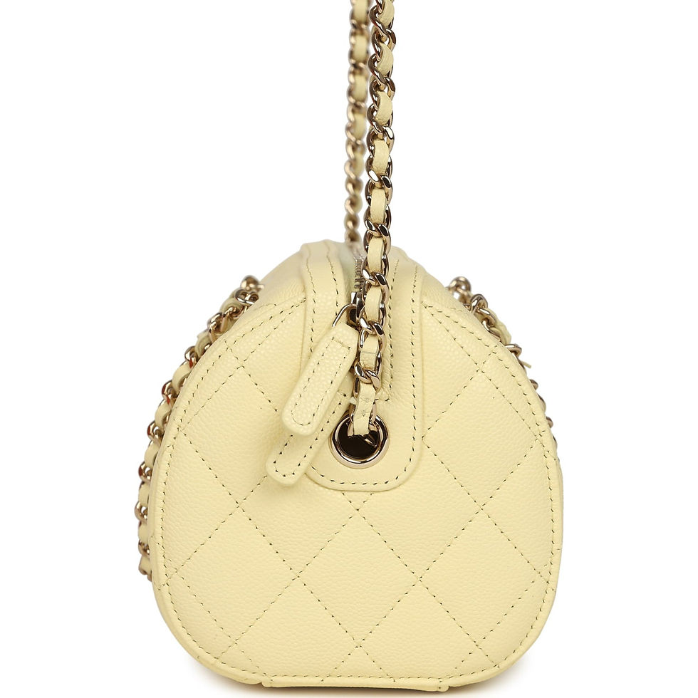 Thumbnail: Side profile of the pale yellow Chanel Mini Timeless Barrel bag showing zip pull