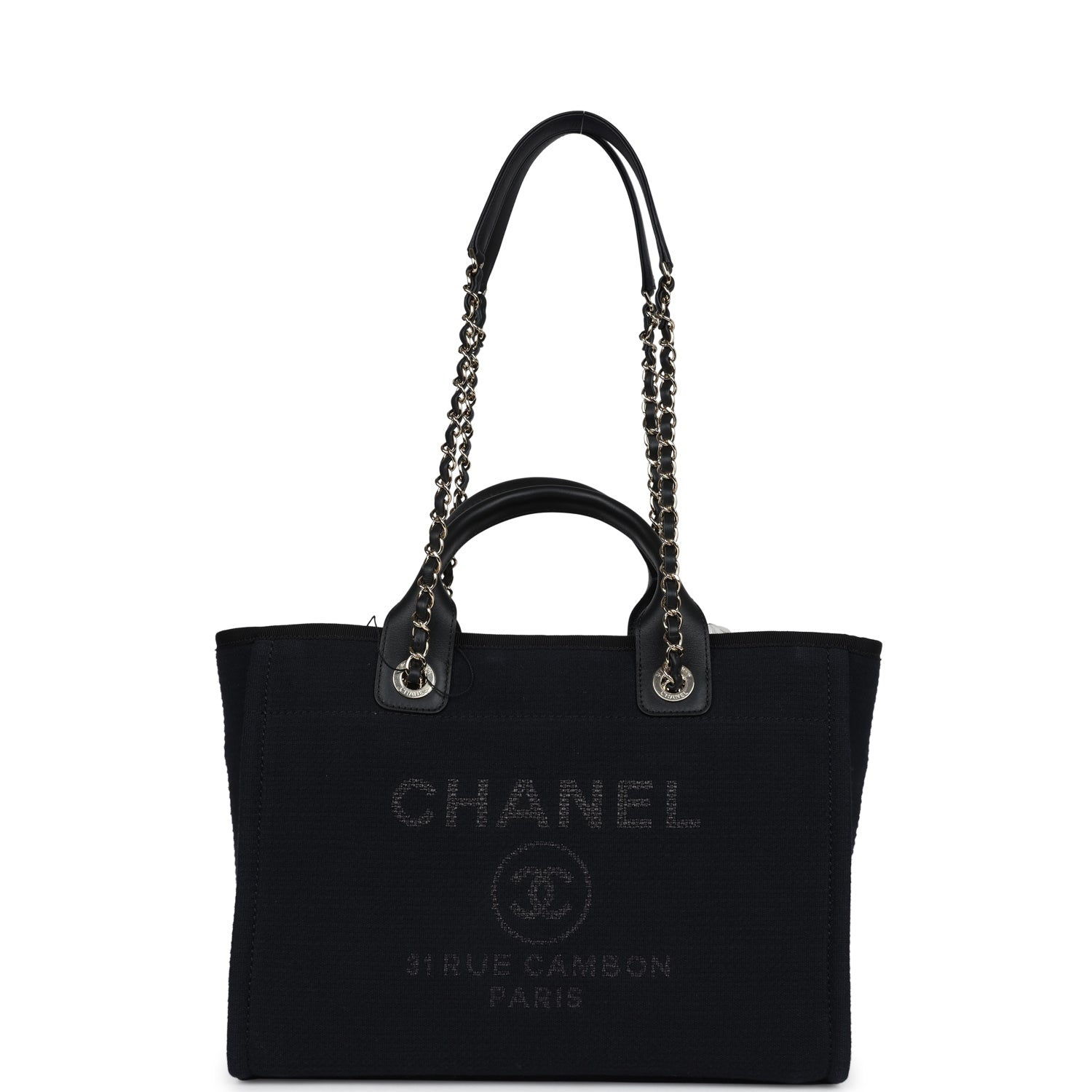 Front view of a black canvas Chanel Deauville tote with tonal logo and gold hardware