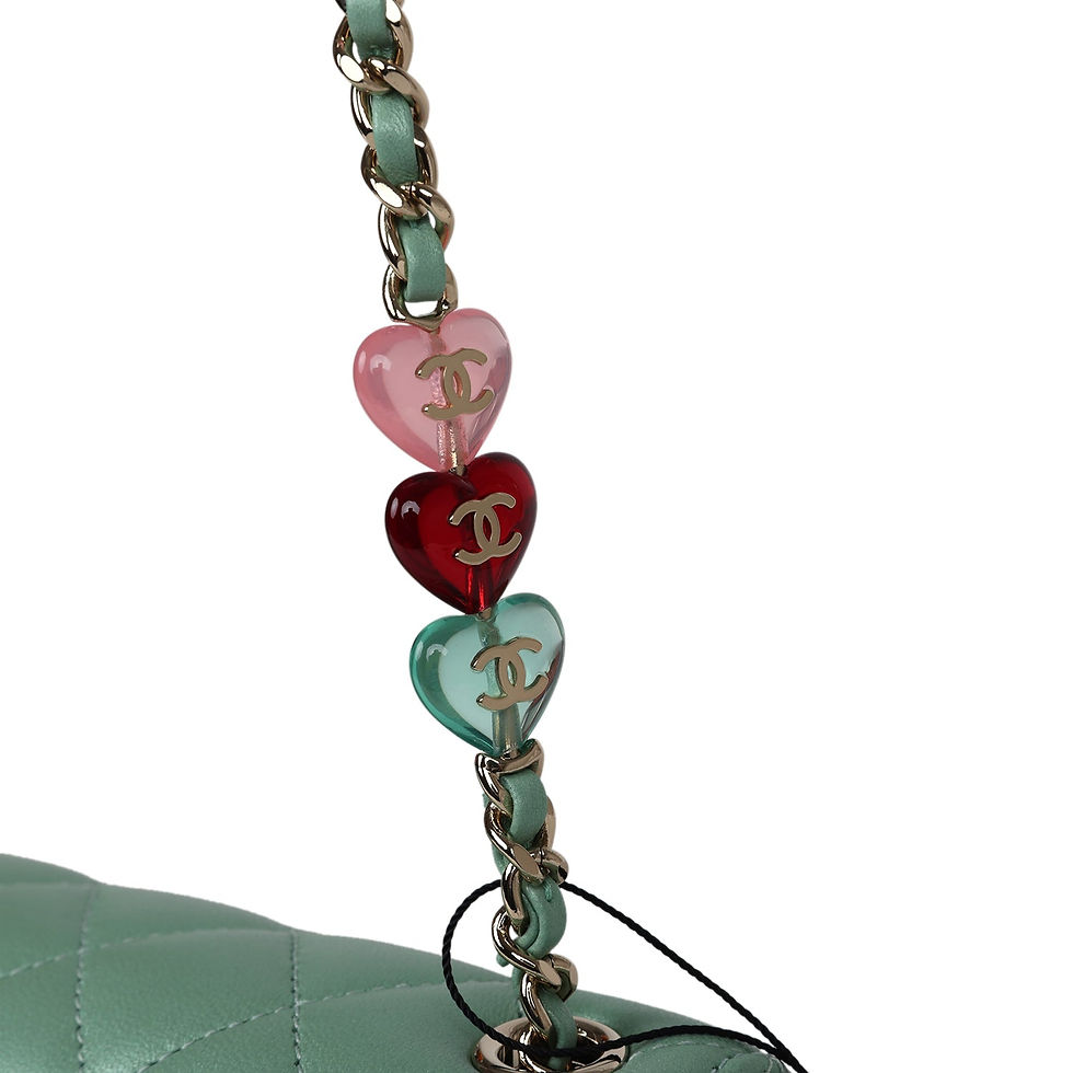 Thumbnail: Front view of the mini flap bag suspended by its beaded and charm-embellished chain strap
