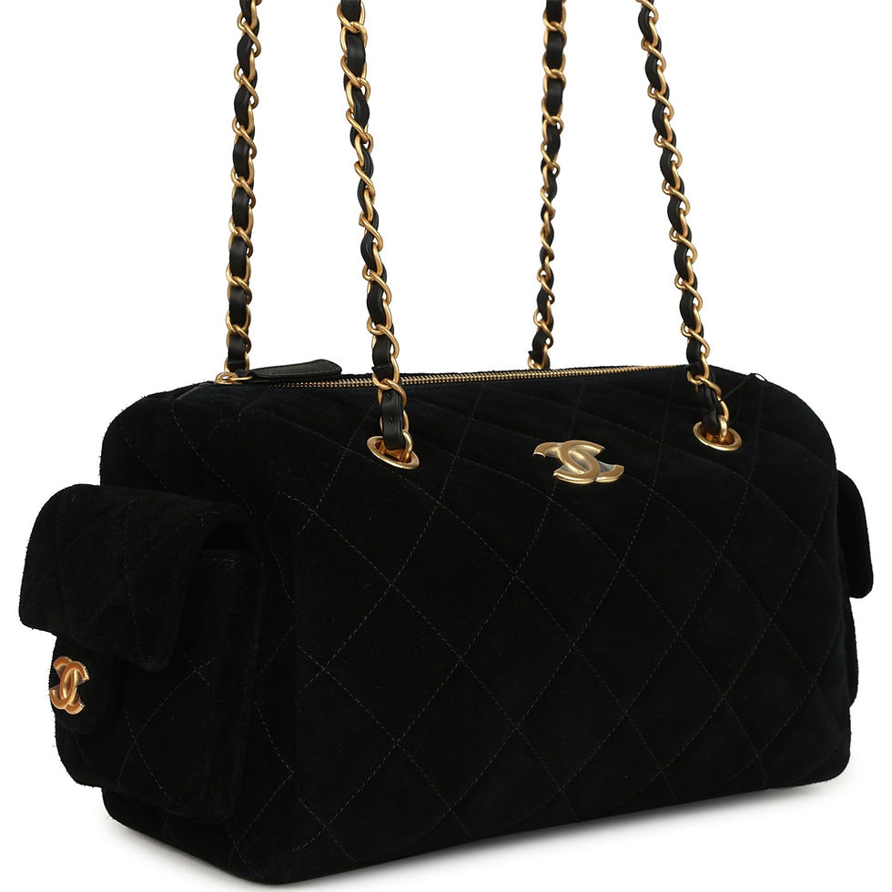 Side-angle view showing the bag's chain-and-leather shoulder strap
