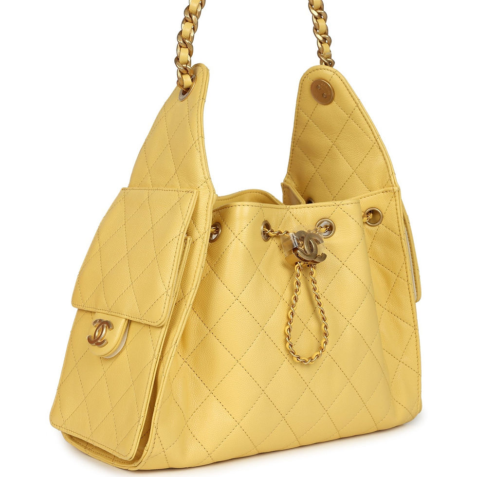 Three-quarter view of the yellow caviar hobo bag showing the side flap pocket and chain strap