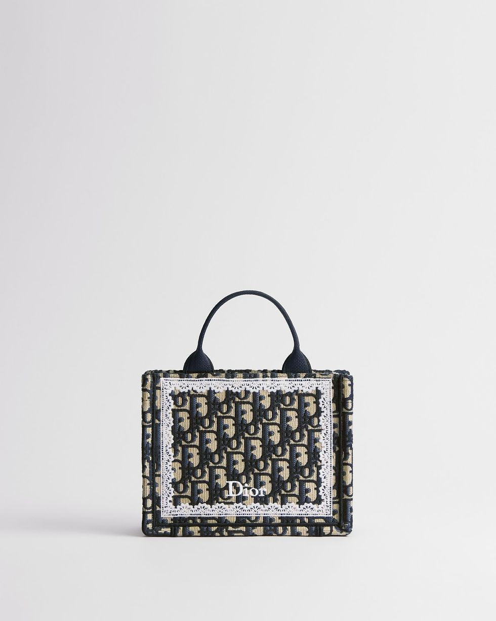 Dior Mini Book Tote with strap in blue Dior Oblique embroidery with lace frame – front view