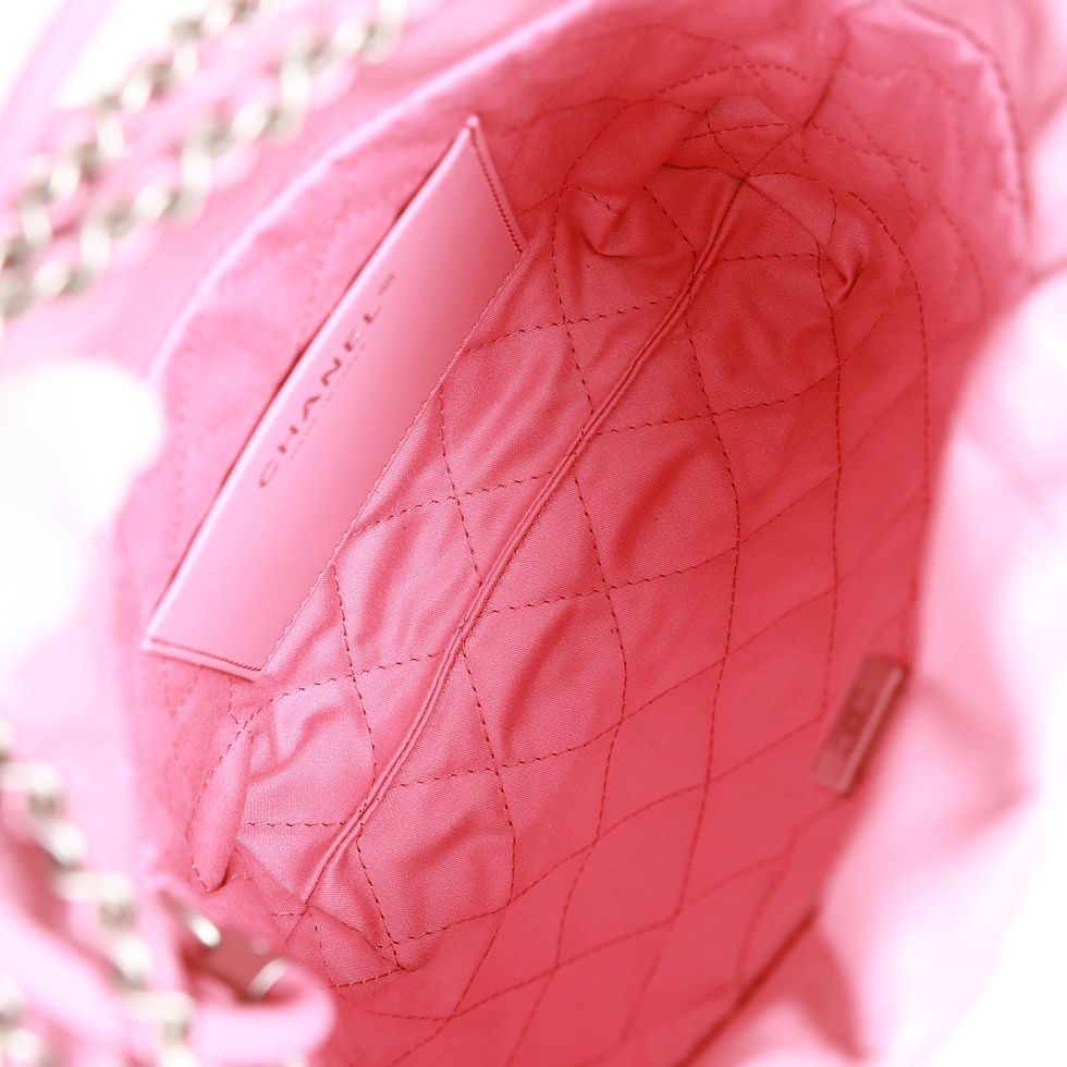 Thumbnail: Interior view of the pink bag showing the quilted fabric lining and card slot