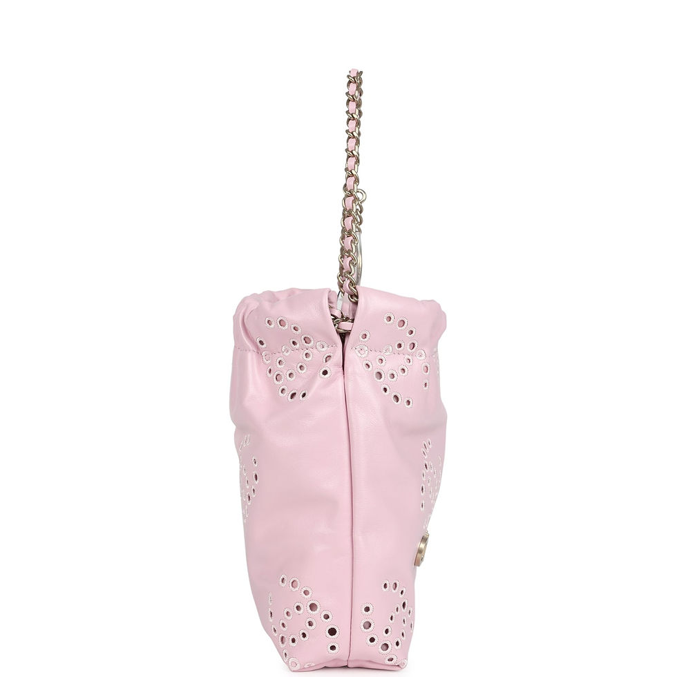 Thumbnail: Side profile of the pink eyelet bag showing its slouchy, unstructured silhouette