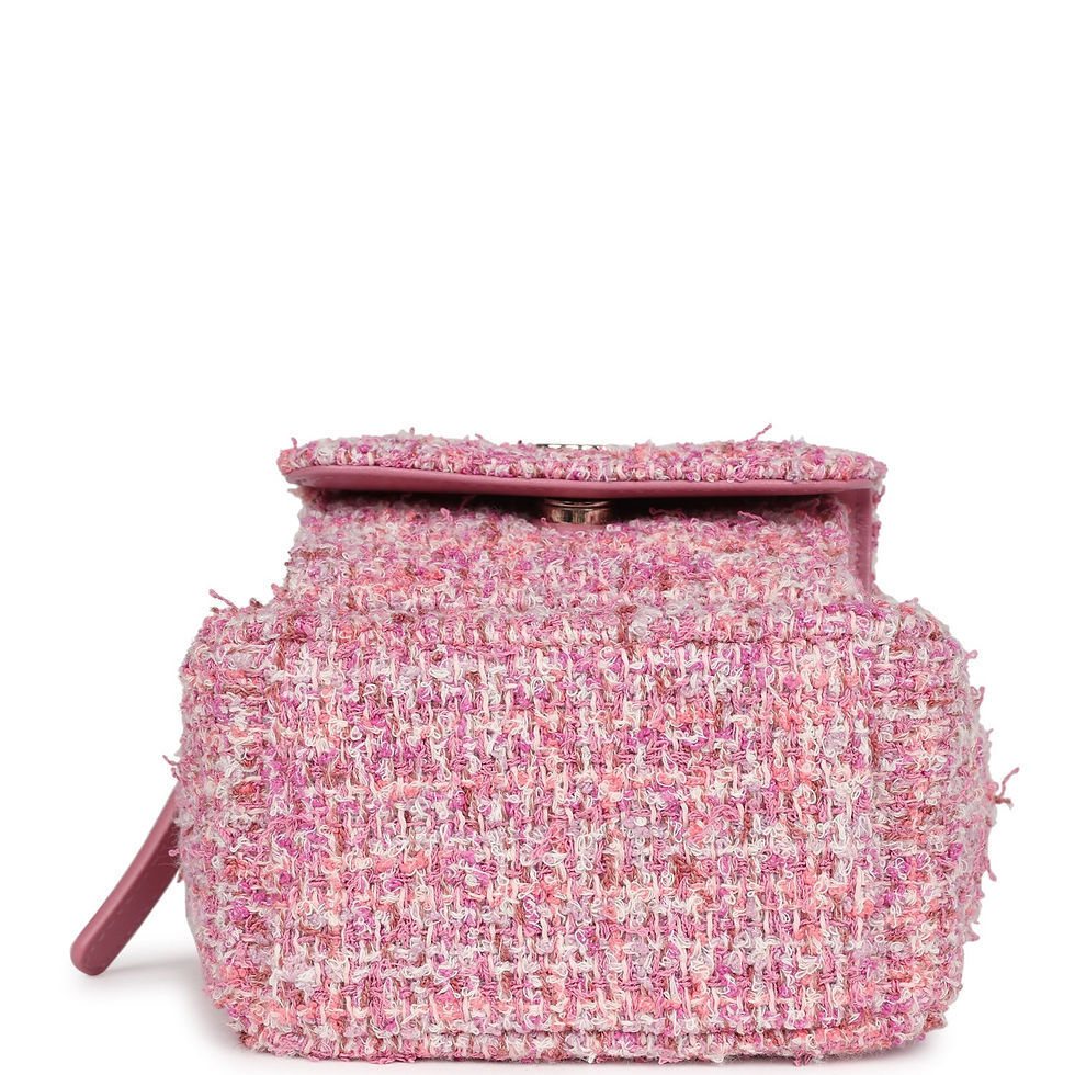 Thumbnail: Side profile of the pink tweed backpack showing the chain-and-leather strap and zip
