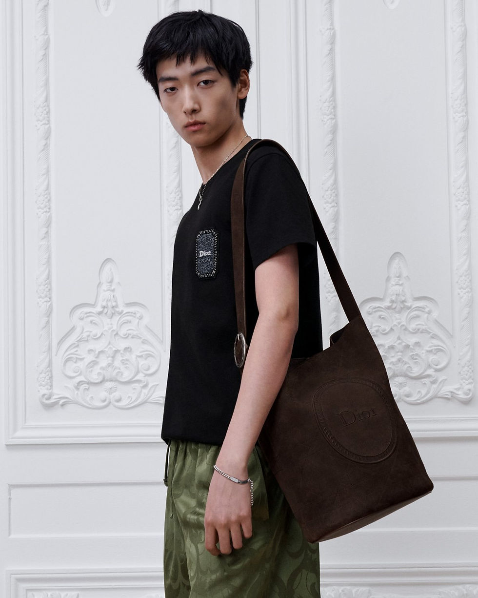 Thumbnail: Dior Jett Médaillon Bucket Bag in Brown Cannage Suede Calfskin – worn on model