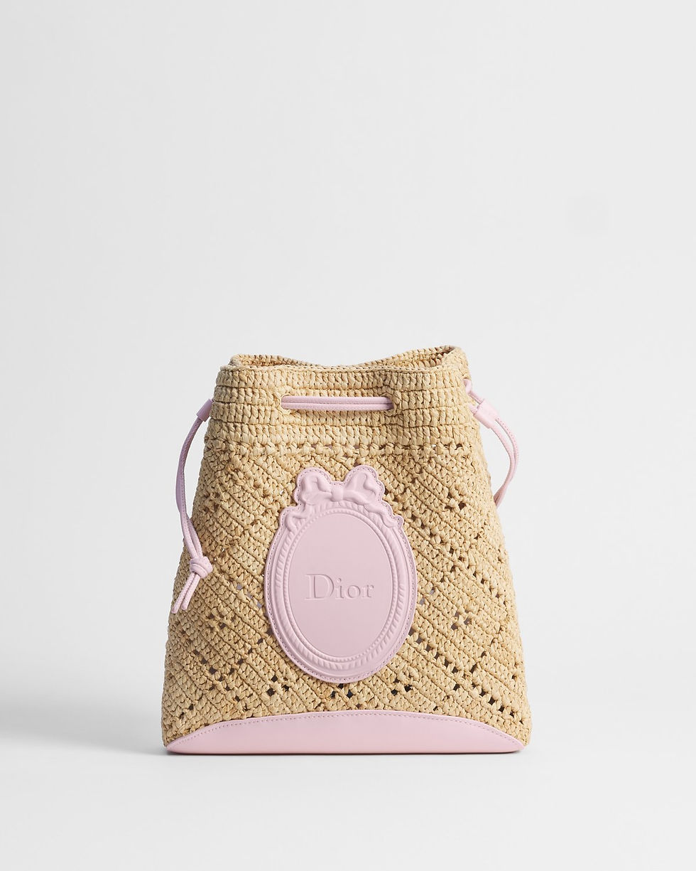 Dior Dioriviera Blooming mini bucket bag in pink openwork raffia – front view