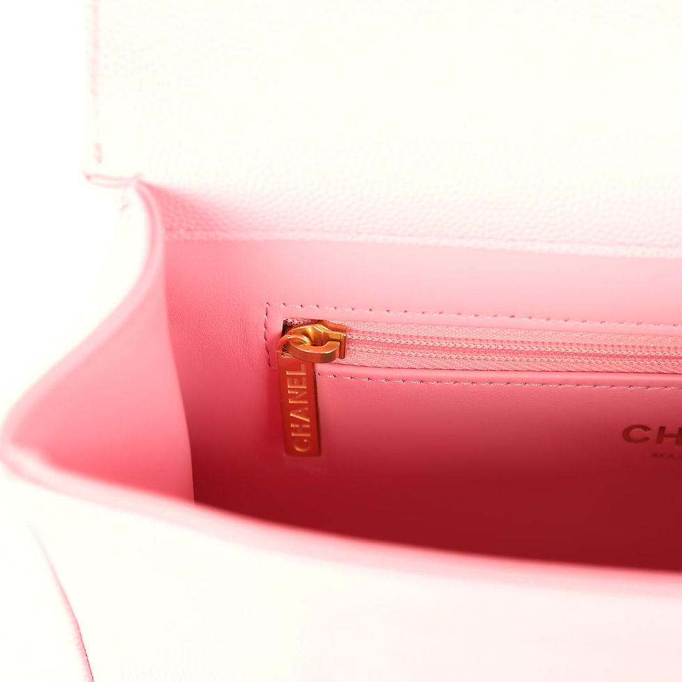 Thumbnail: Close-up of the interior zip pull tab embossed with the Chanel name