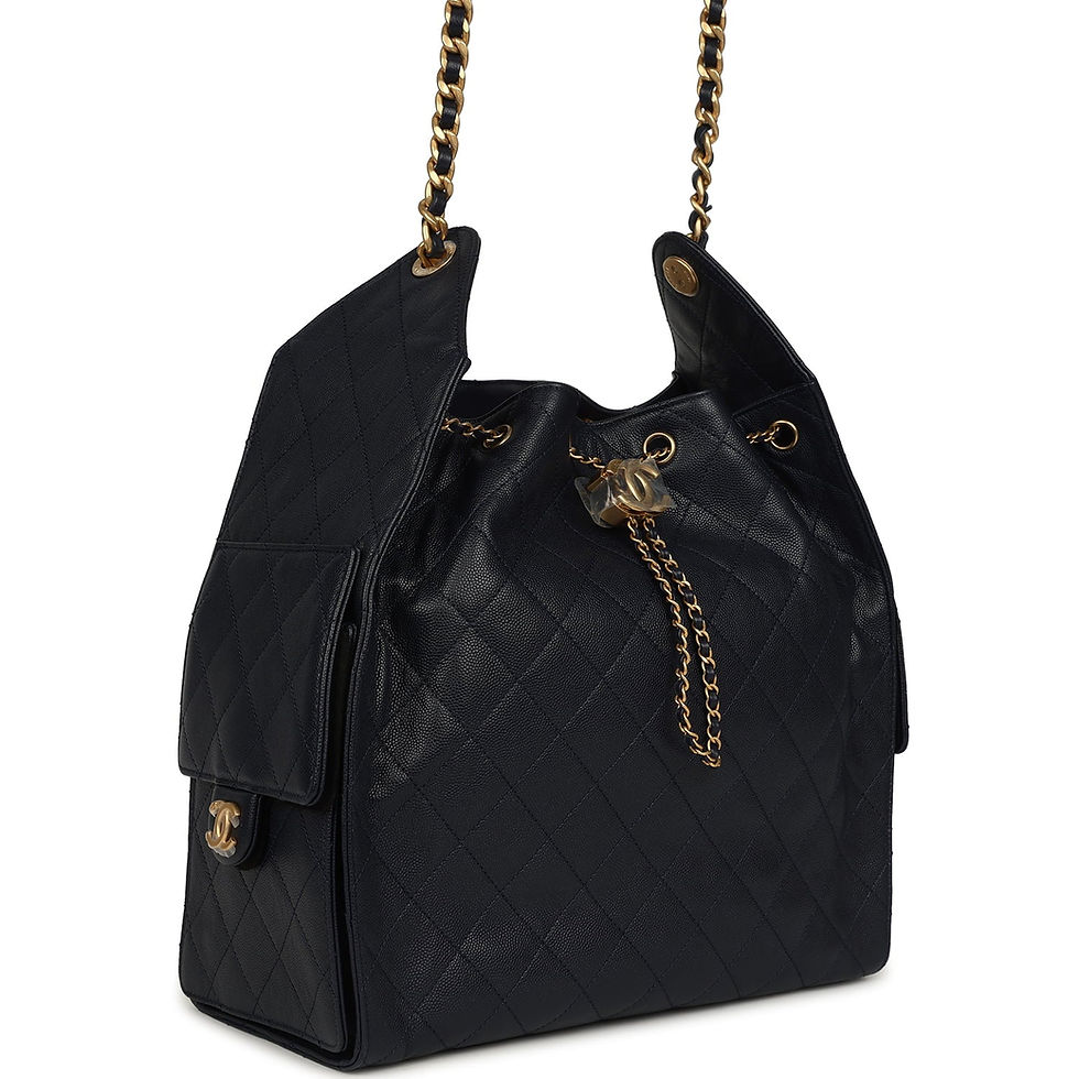 Angled front view of the navy quilted hobo showing chain drawstring and side pocket