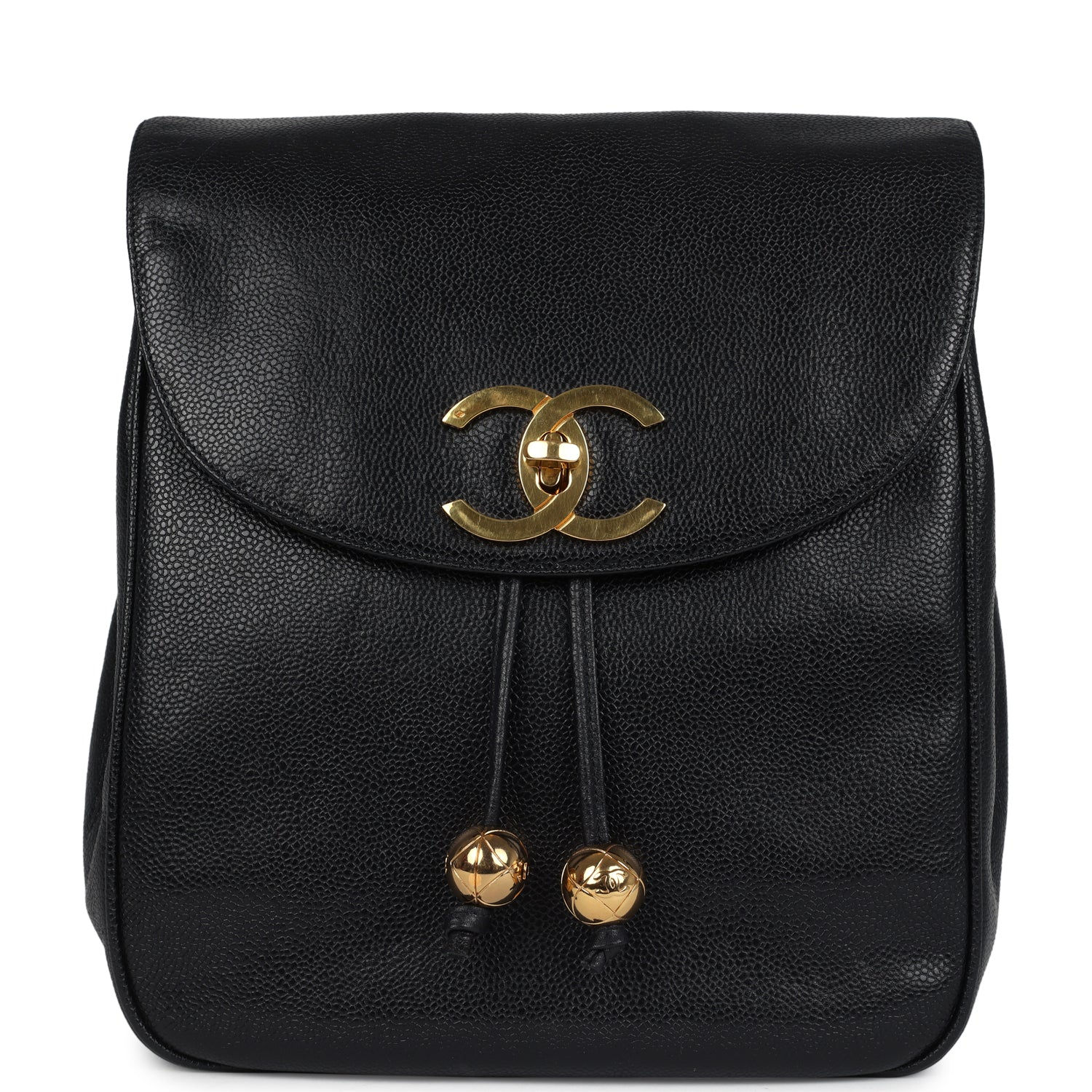Front view of the vintage Chanel CC backpack in black caviar with gold turnlock and drawstring balls