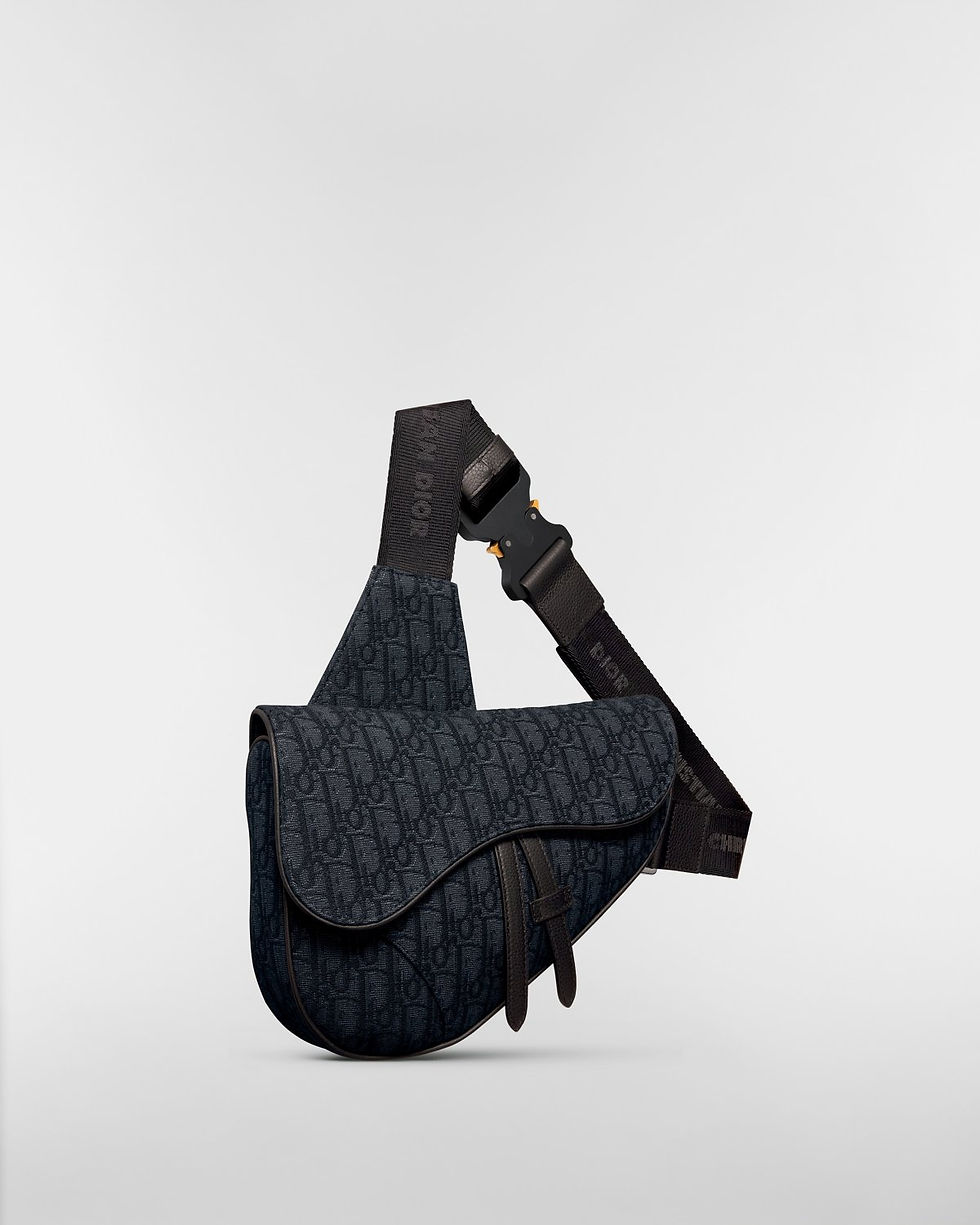 Dior Saddle bag in black Dior Oblique jacquard – three-quarter view with strap