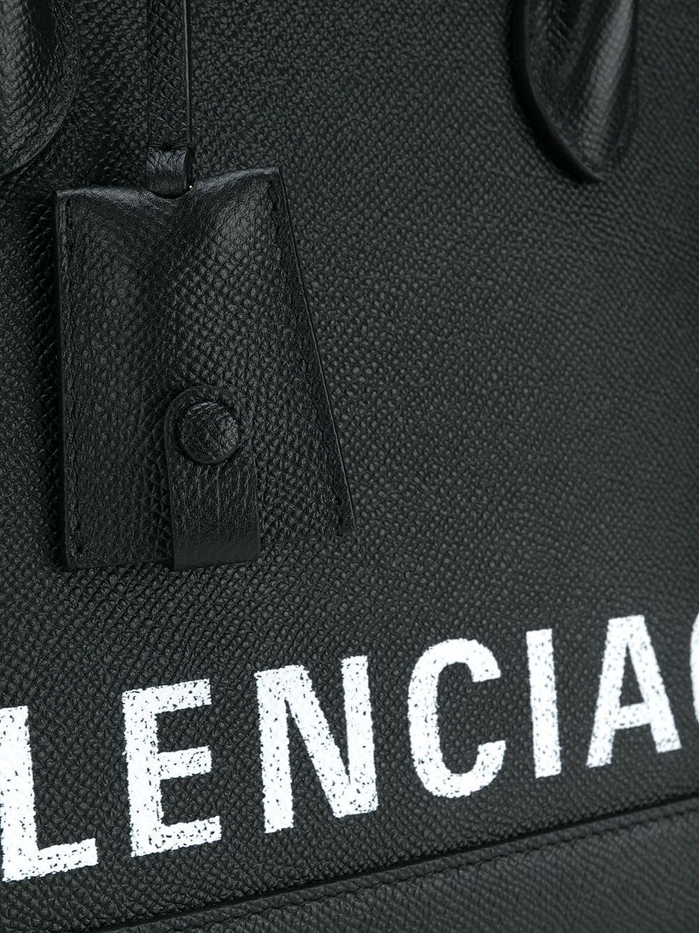 Close-up of the BALENCIAGA logo print on the black Ville bag