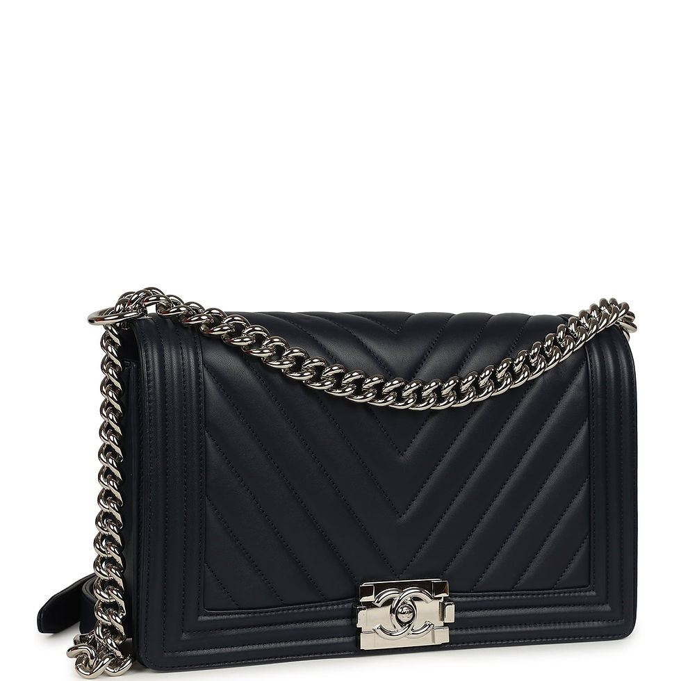 Three-quarter view of the navy chevron Boy Bag showing the quilted flap and CC push-lock clasp