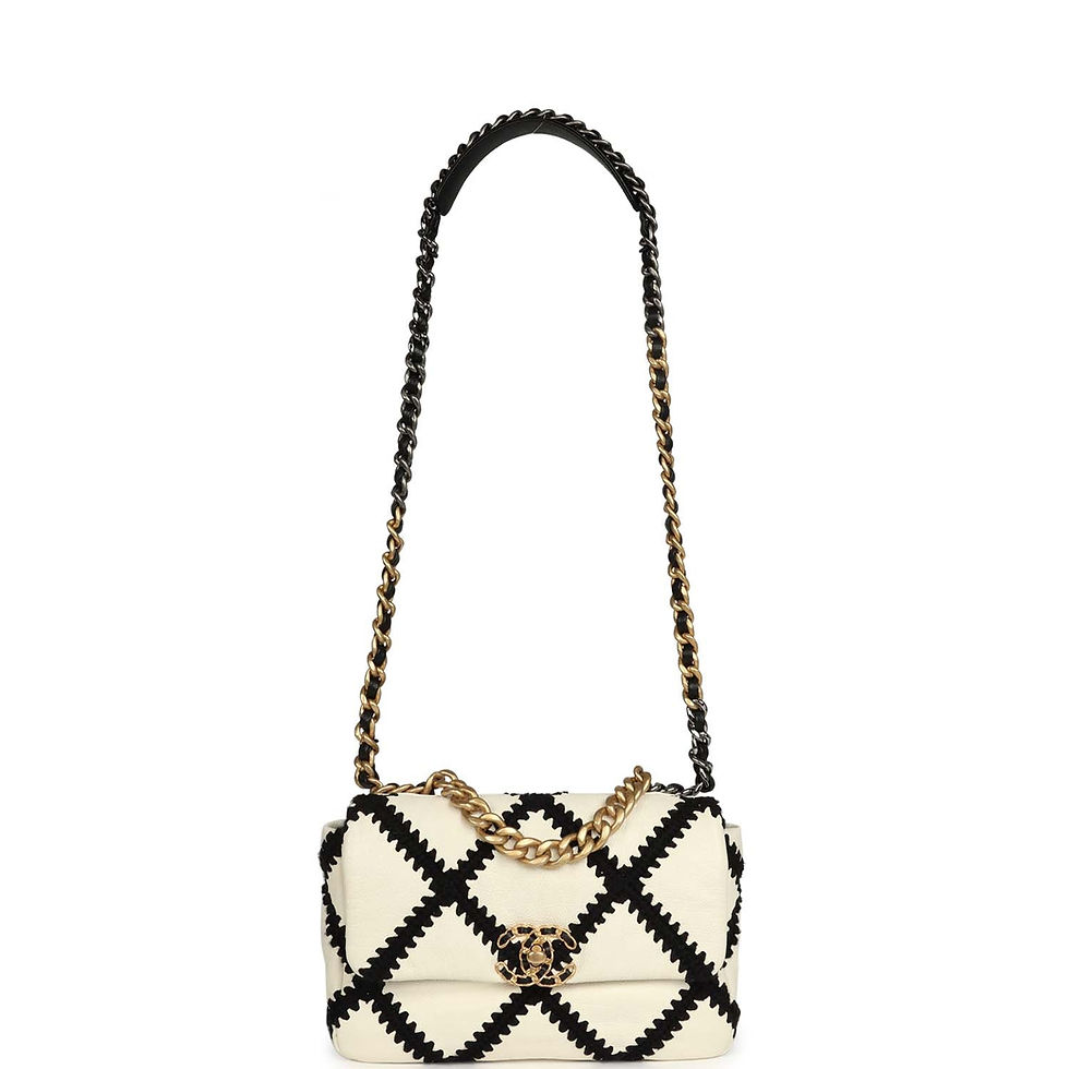 Thumbnail: Full-length front view of the white and black crochet flap bag hanging from its chain strap