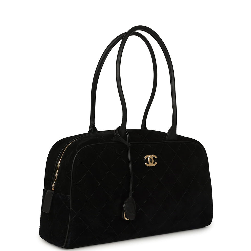 Side-angle view showing the bag's rolled handles and quilted suede texture