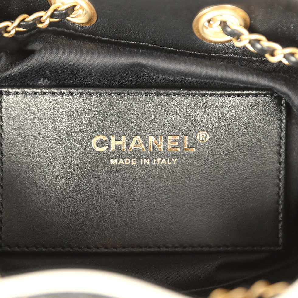 Thumbnail: Close-up of the Chanel Made in Italy stamp on the black interior leather tab