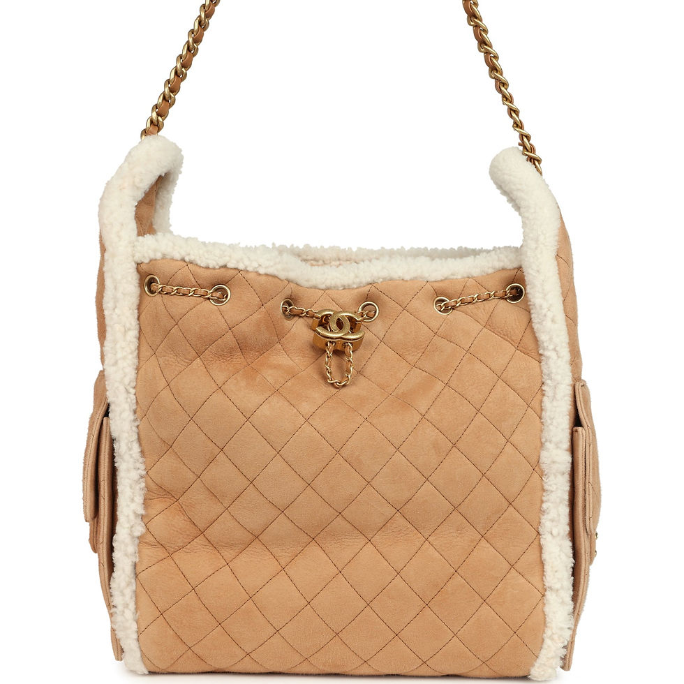 Front view of the beige suede Chanel 25 Medium bag framed with white shearling trim