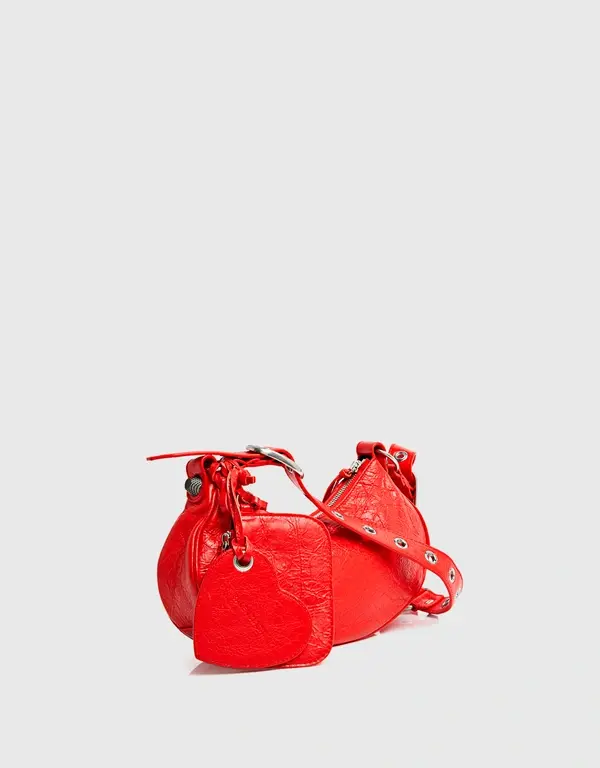 Thumbnail: Front view of the red studded Balenciaga Le Cagole XS bag