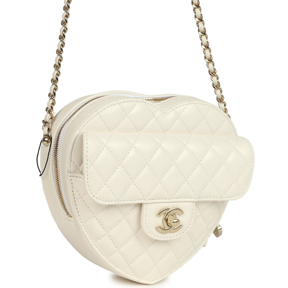 Three-quarter view of the white heart bag showing the zip-top opening and chain strap
