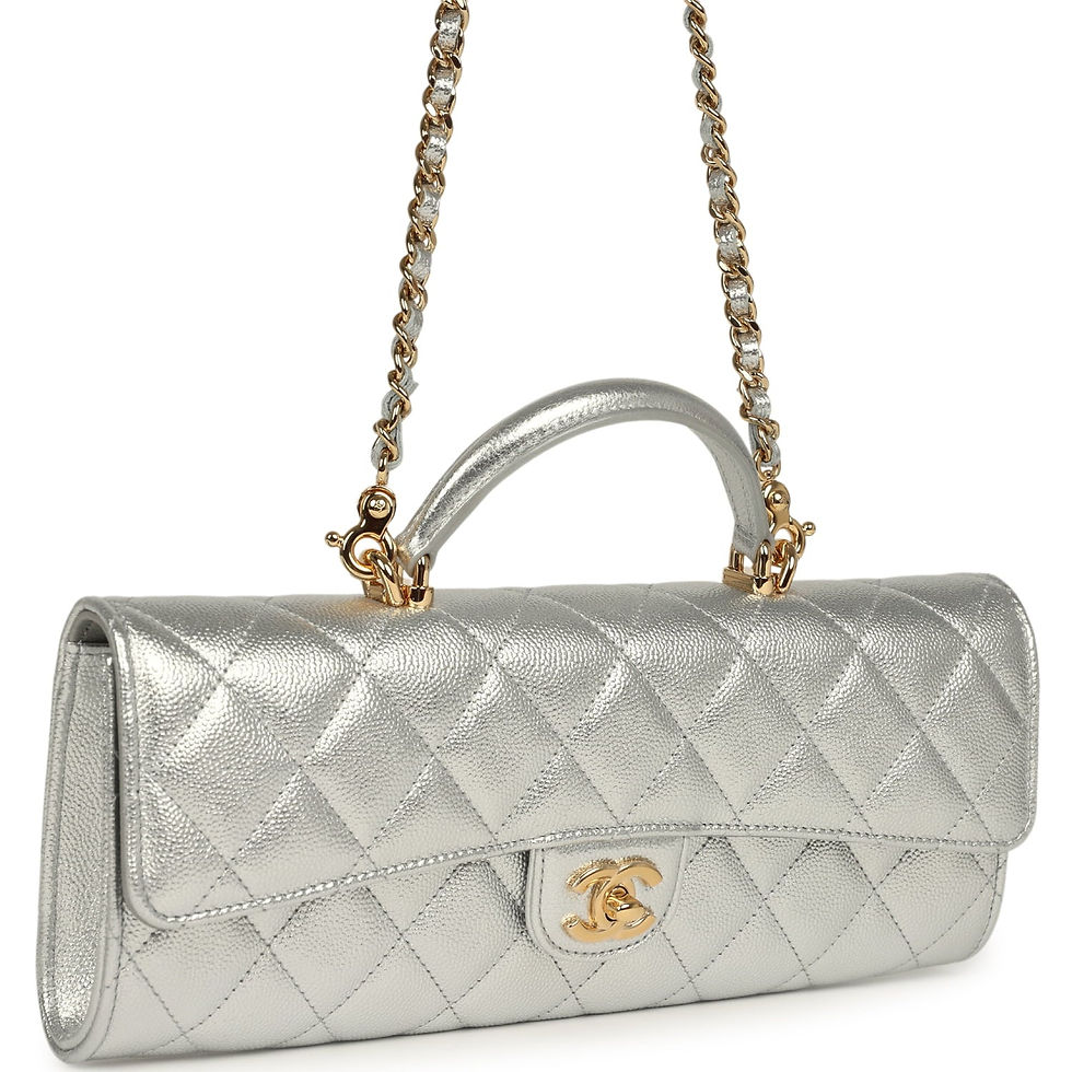 Front view of Chanel metallic silver clutch resting flat with rolled handle