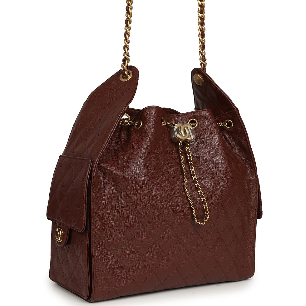 Angled front view of the brown quilted bag showing its chain drawstring and side pocket