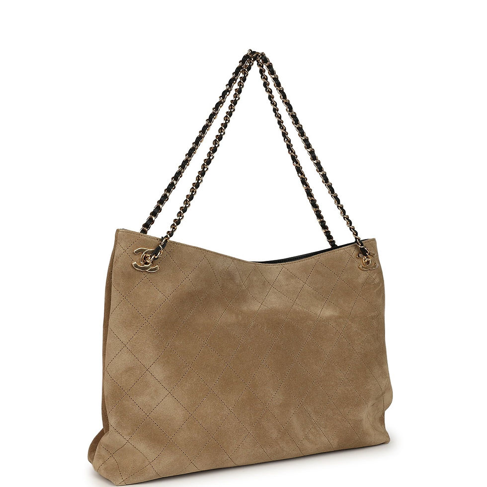Three-quarter view of the tote showing the chain-and-leather strap and suede texture
