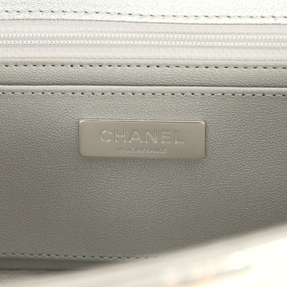 Thumbnail: Close-up of the Chanel Made in France plaque on the grey leather interior