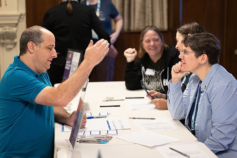 Amplify volunteers in conversation around a table