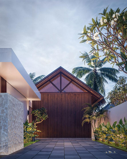 Modern wooden entrance and stone wall of a luxury villa in Serangan South Lombok.