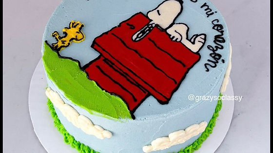 Snoopy on top of the doghouse birthday cake