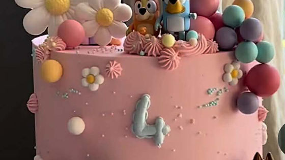 Bluey themed cake with a rainbow