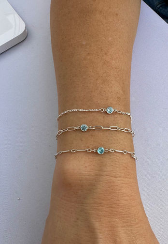 A woman's wrist adorned with permanent bracelets