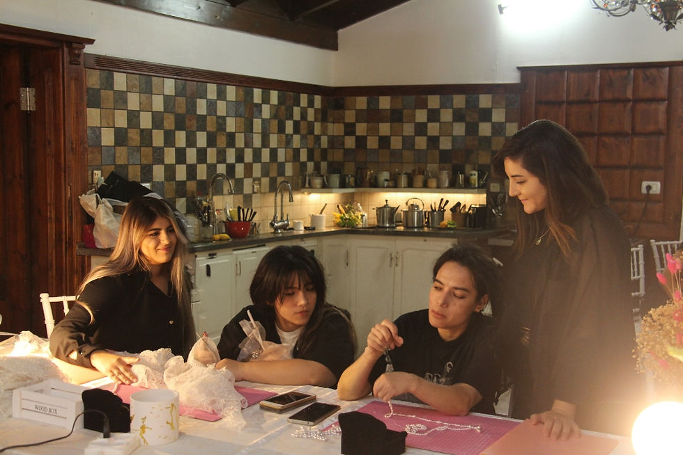 Four young people working together on a project in a kitchen.