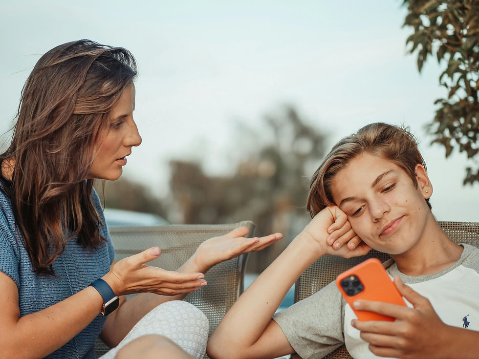Bewildered Mom with Teen boy and cell phone