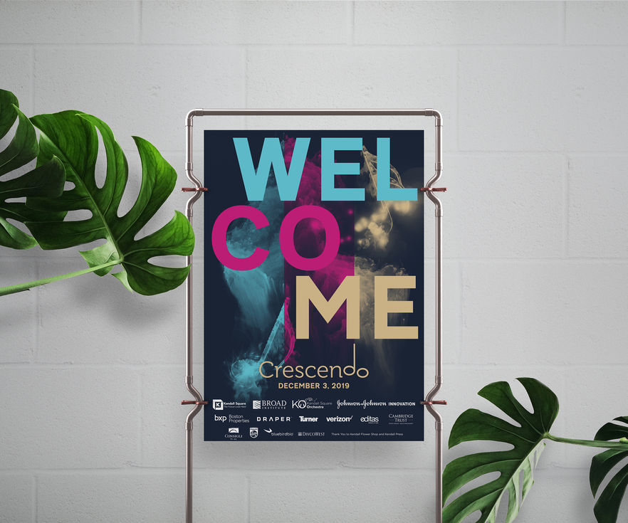 Poster reading “Welcome Crescendo” displayed at venue entrance with plants around.