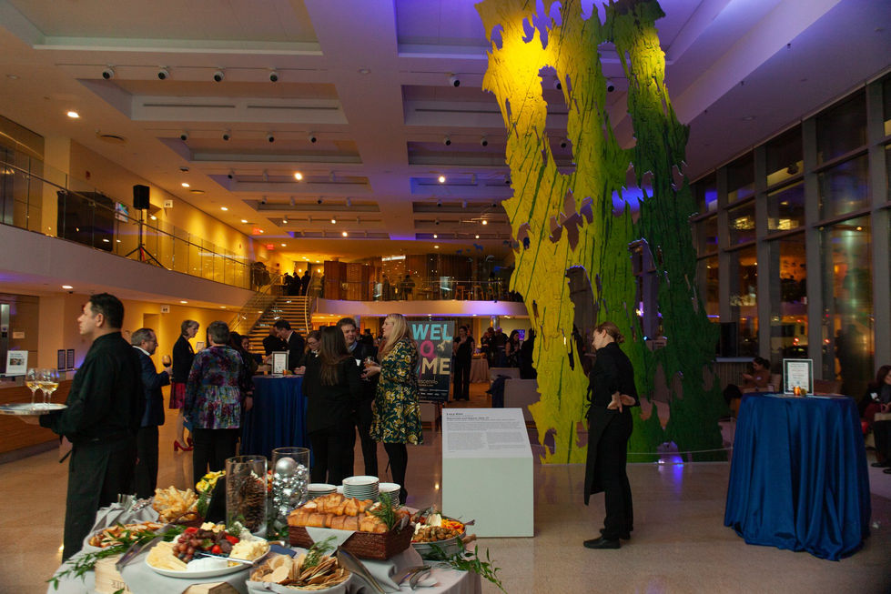 Reception scene at Crescendo event with catering table and welcome signage.