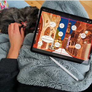 Francesca Watt illustrating on iPad Pro with her dog Lola for company.